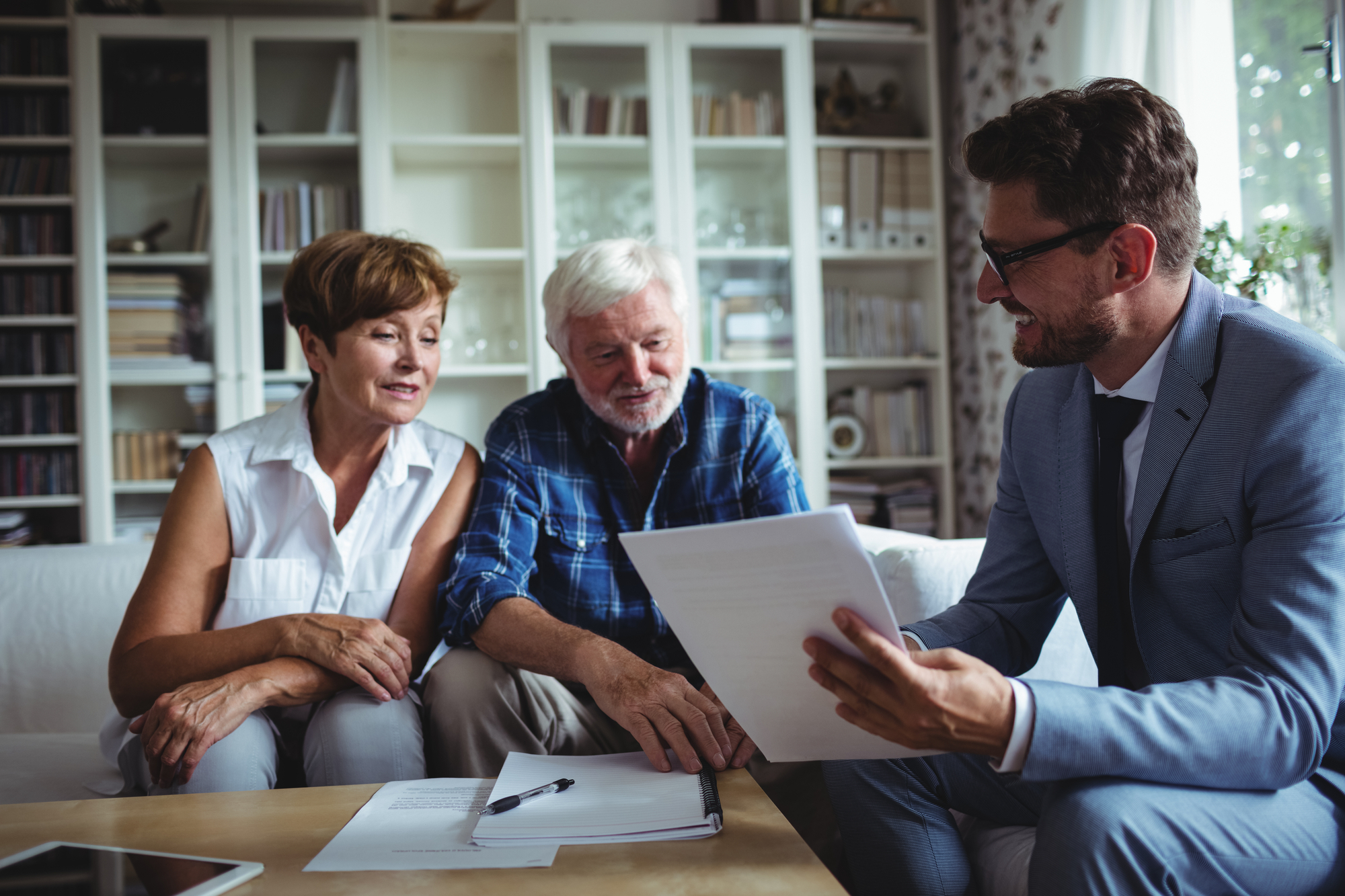 senior couple reviewing documents with lawyer